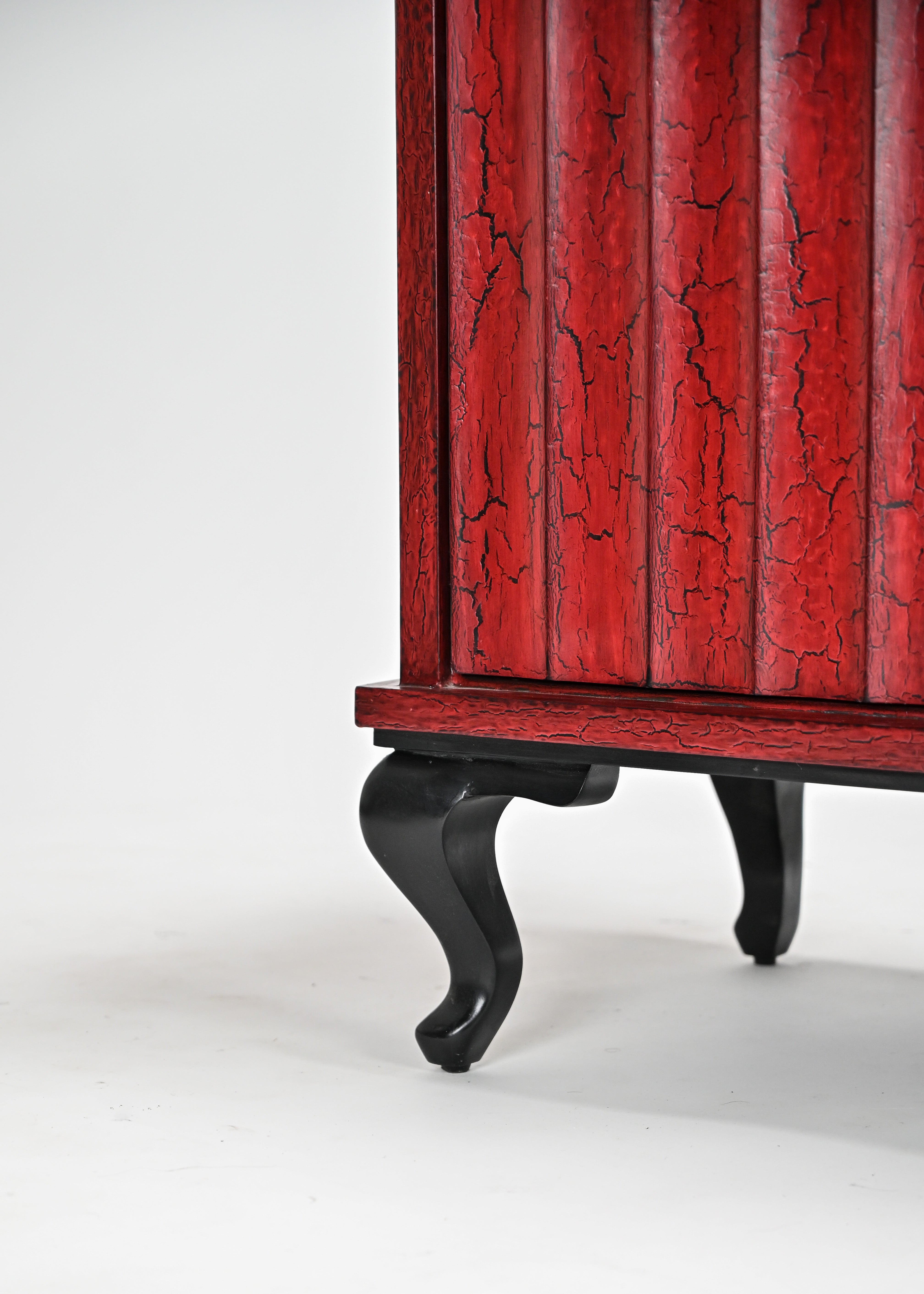 Red wooden cabinet with black legs on a white background
