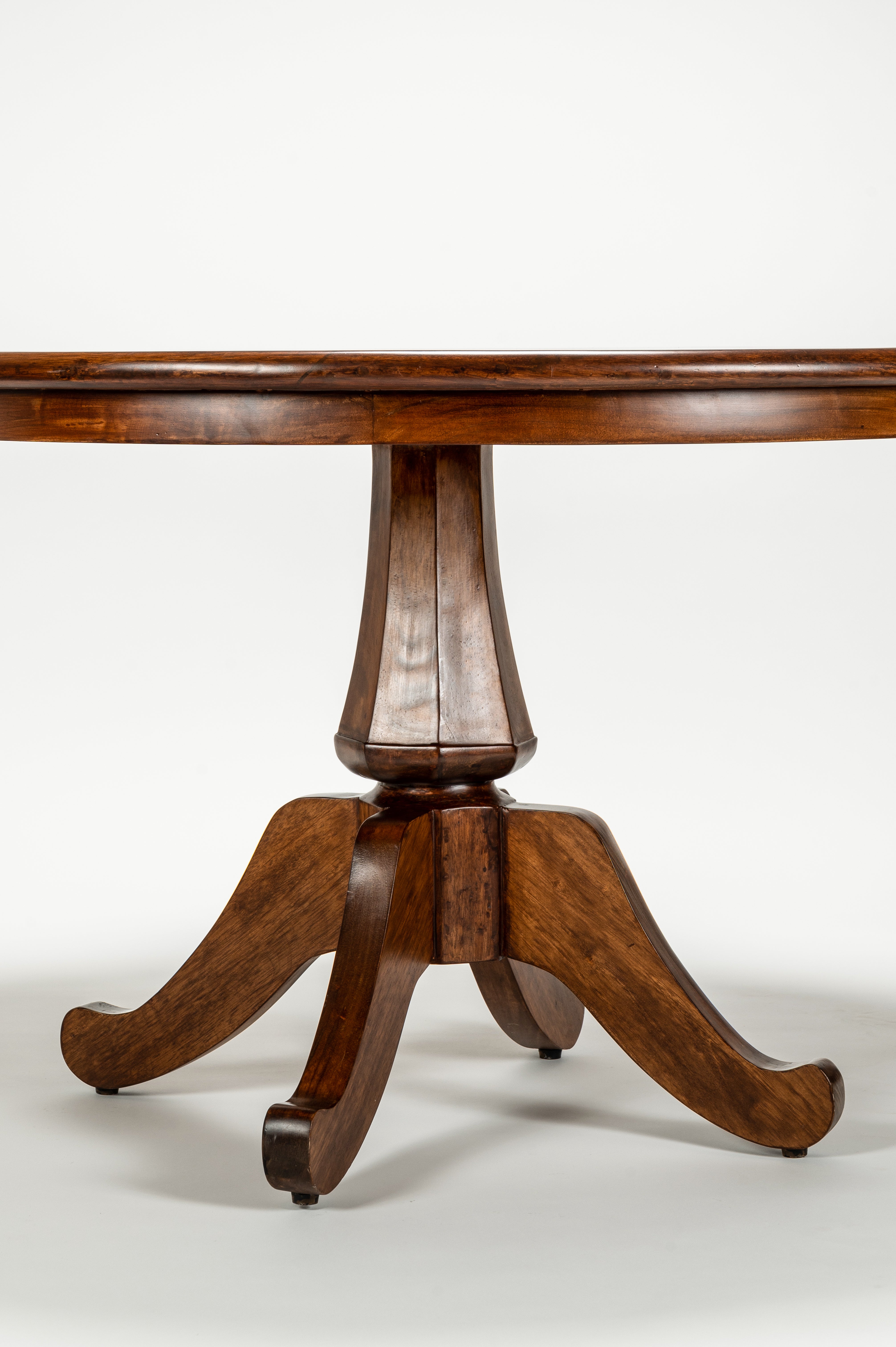 Wooden pedestal table on a white background