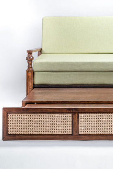 Wooden bed with green mattress on a white background