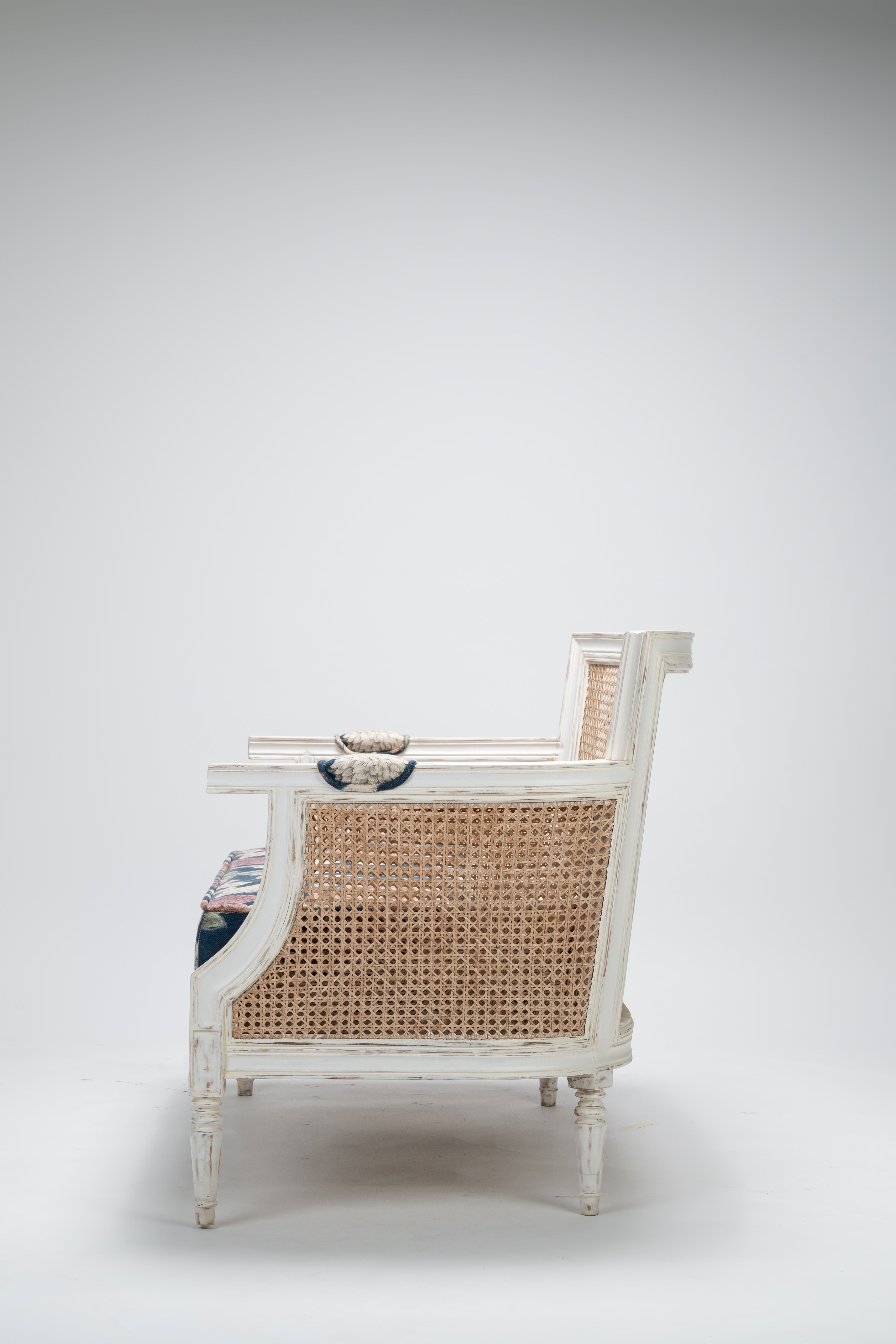 White wicker chair with a striped cushion on a white background
