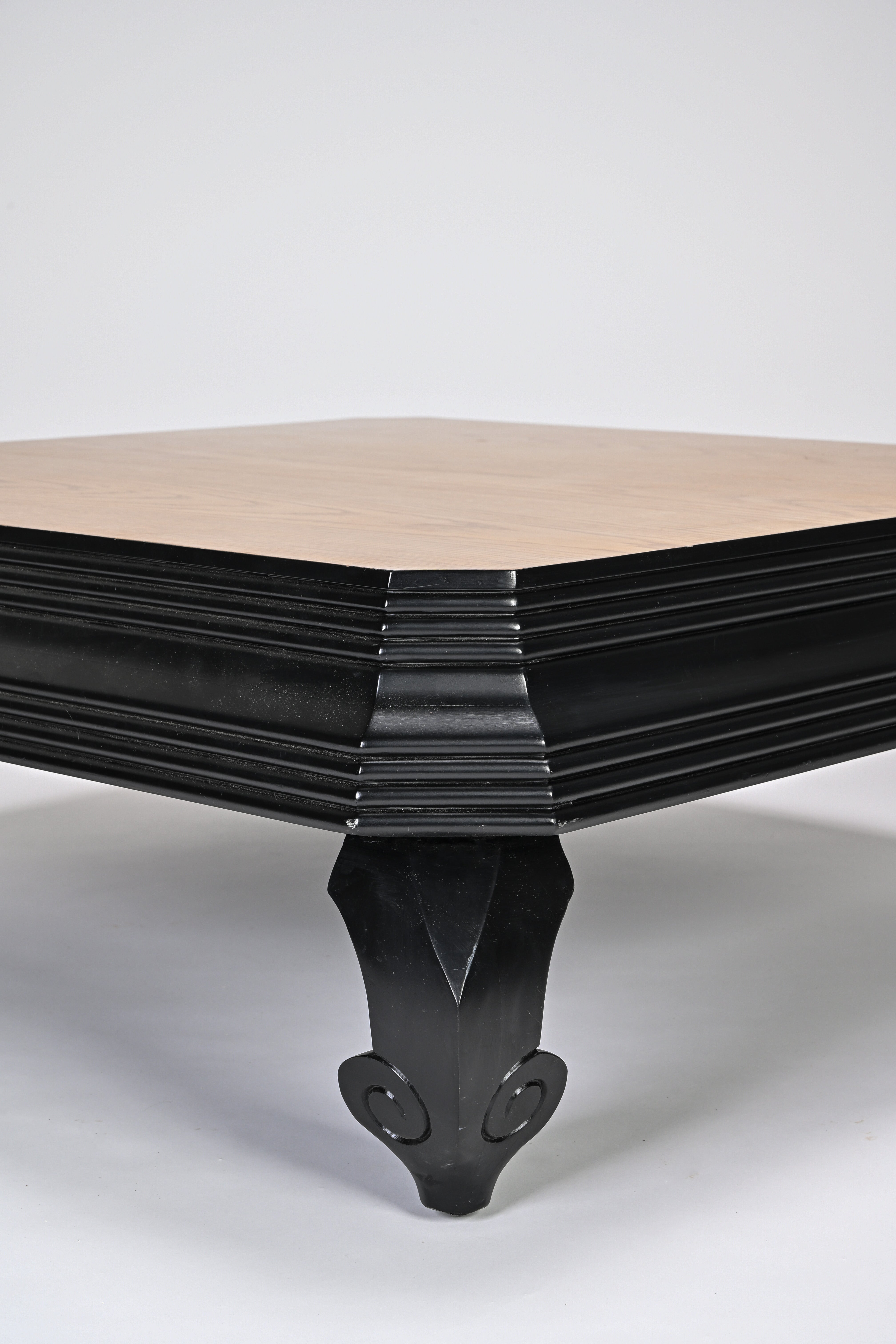 Wooden table with black metal base on a white background