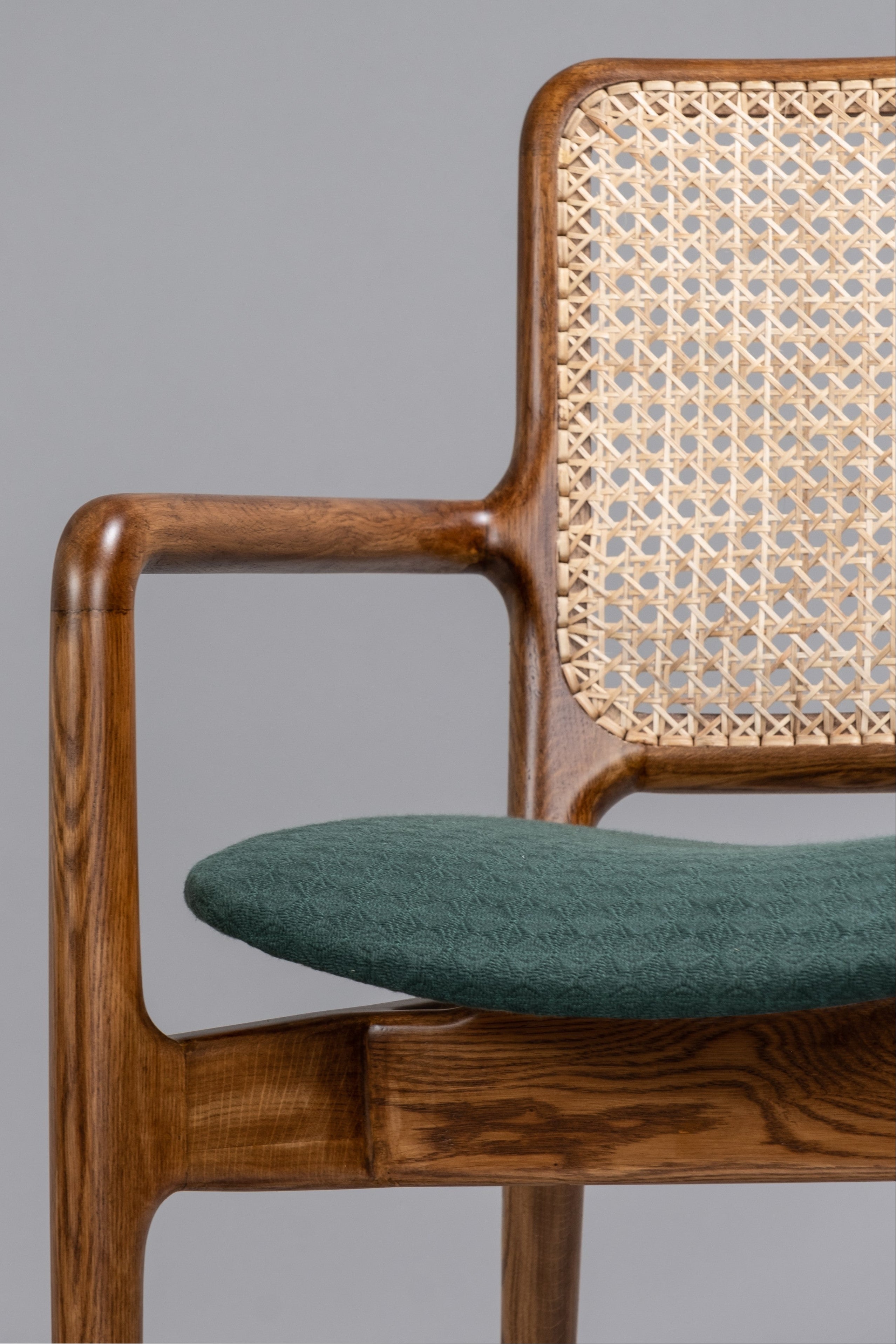 Chair with wooden frame and wicker backrest on a gray background