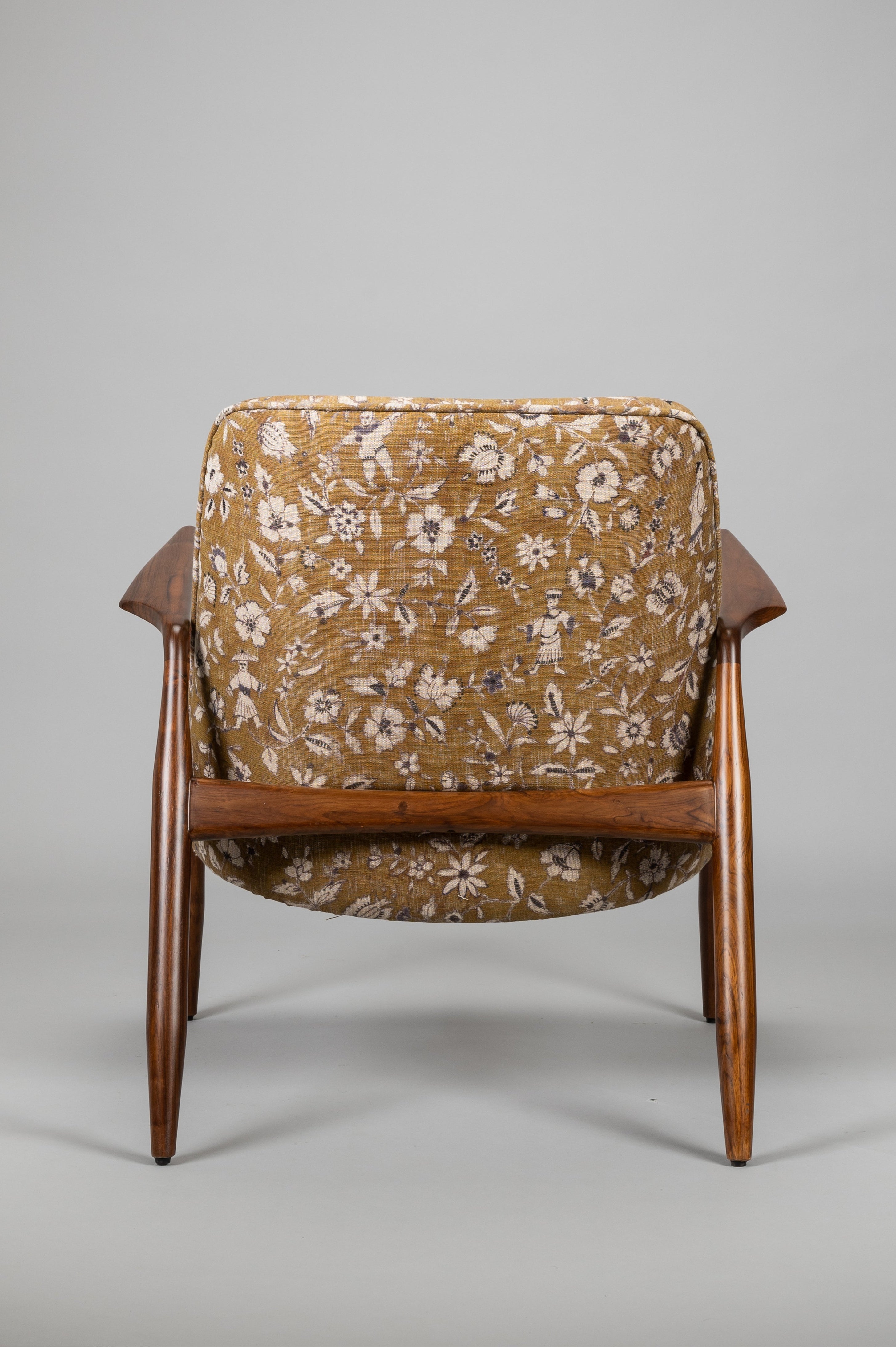 Chair with floral patterned cushion on a gray background