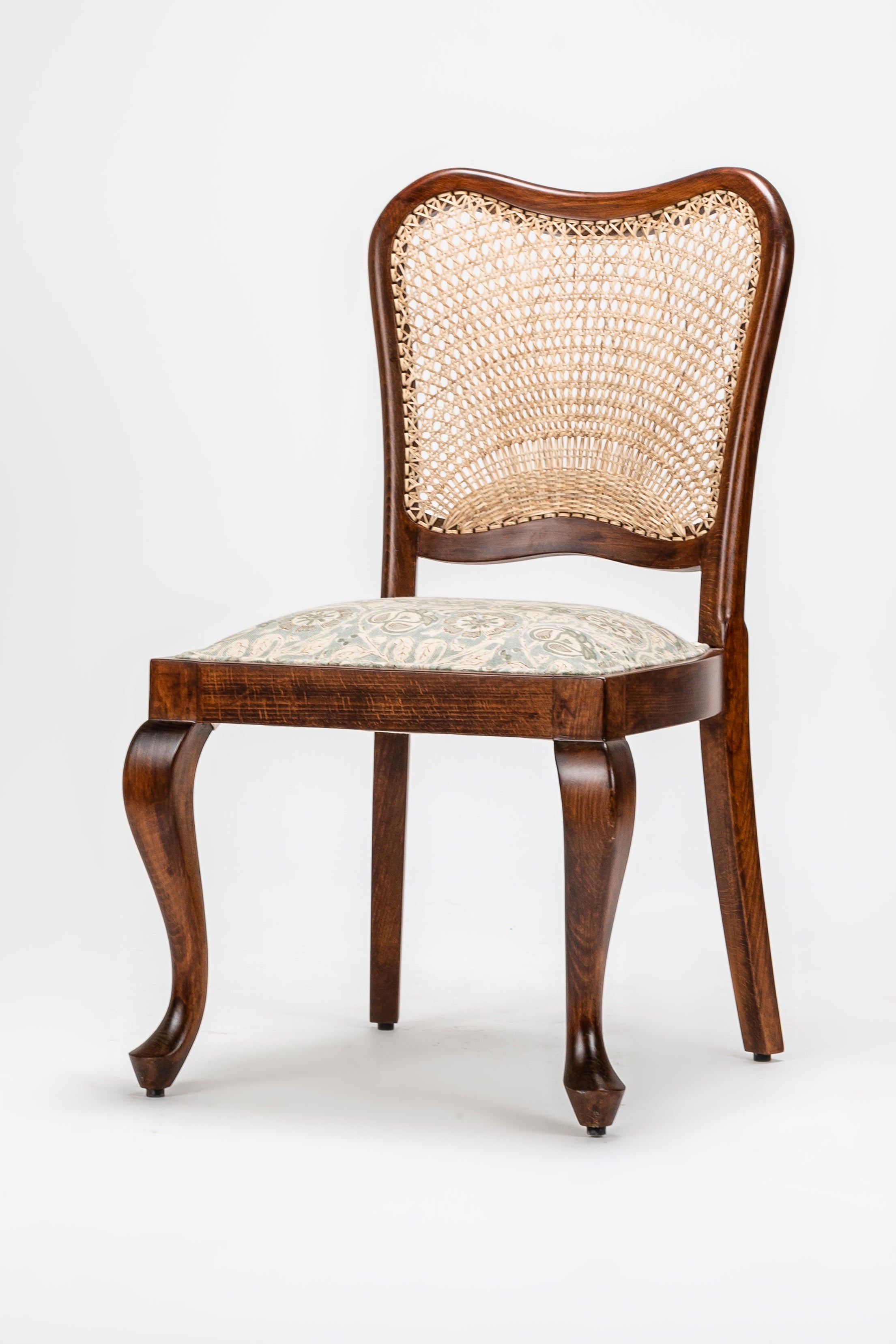 Wooden chair with a wicker backrest on a white background