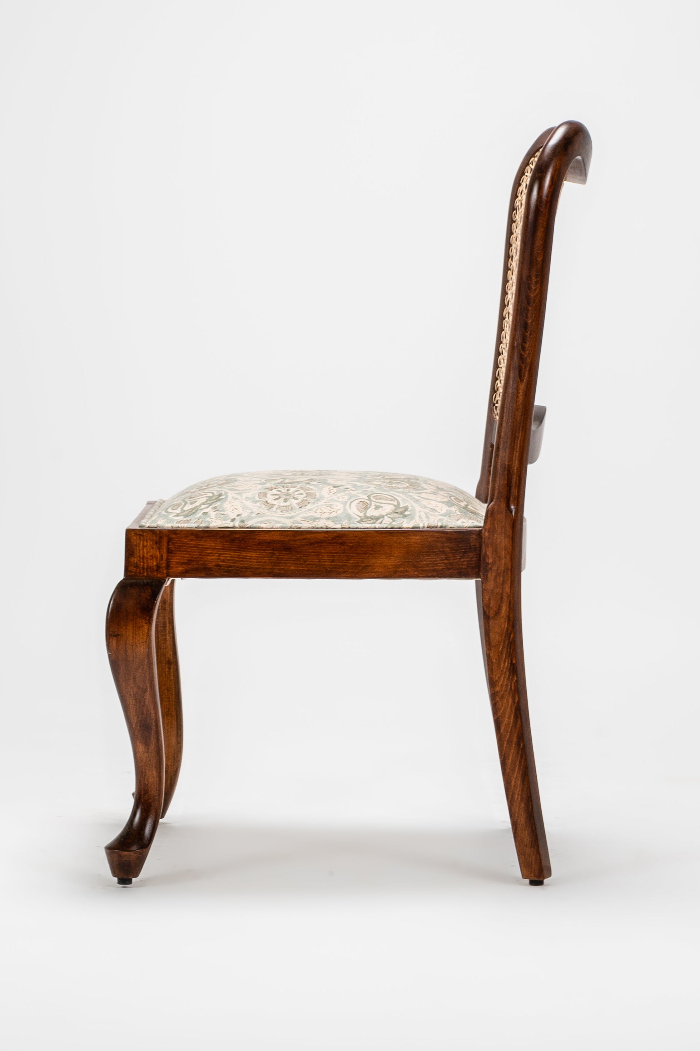 Wooden chair with a white cushion on a light gray background