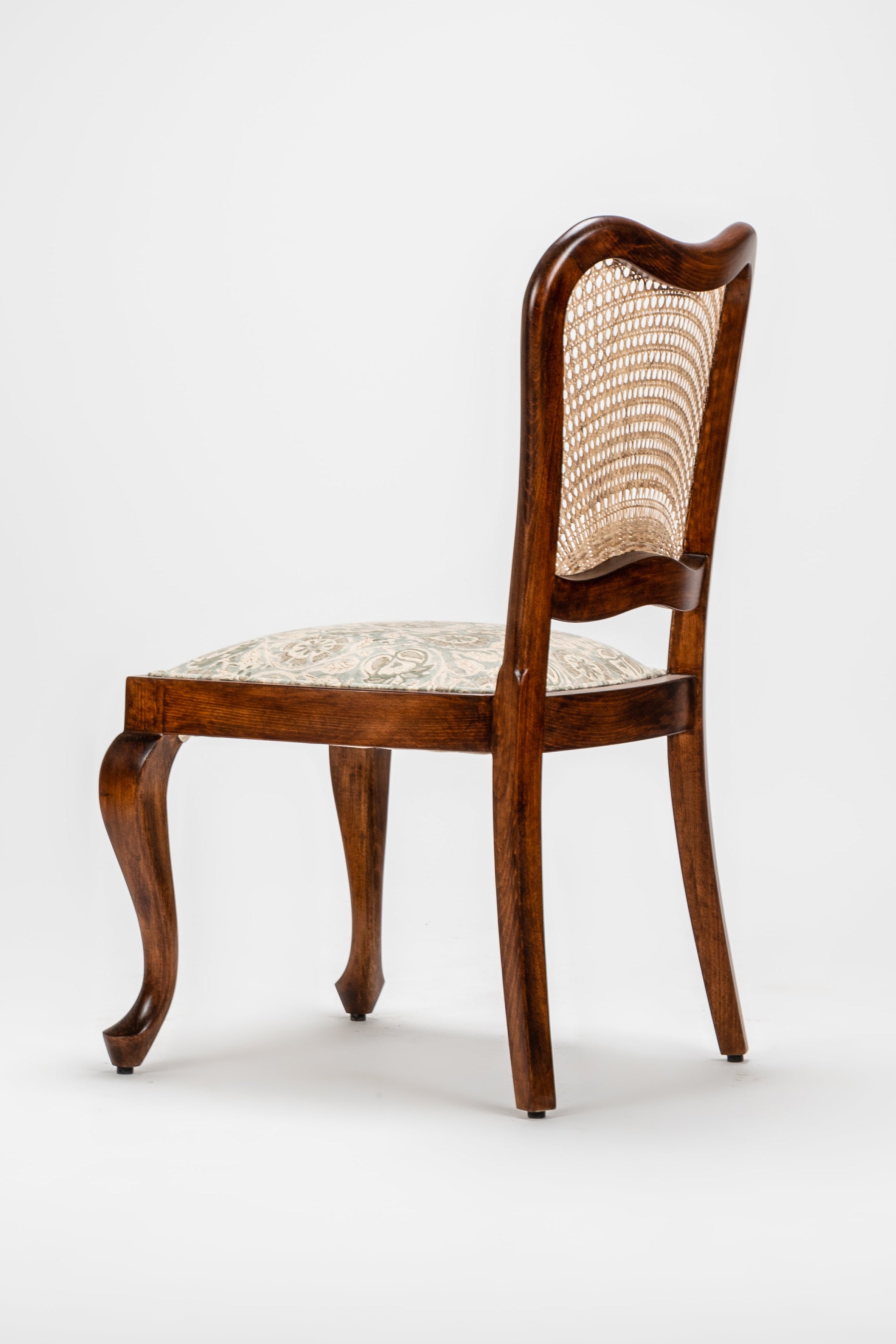 Wooden chair with a woven backrest on a white background