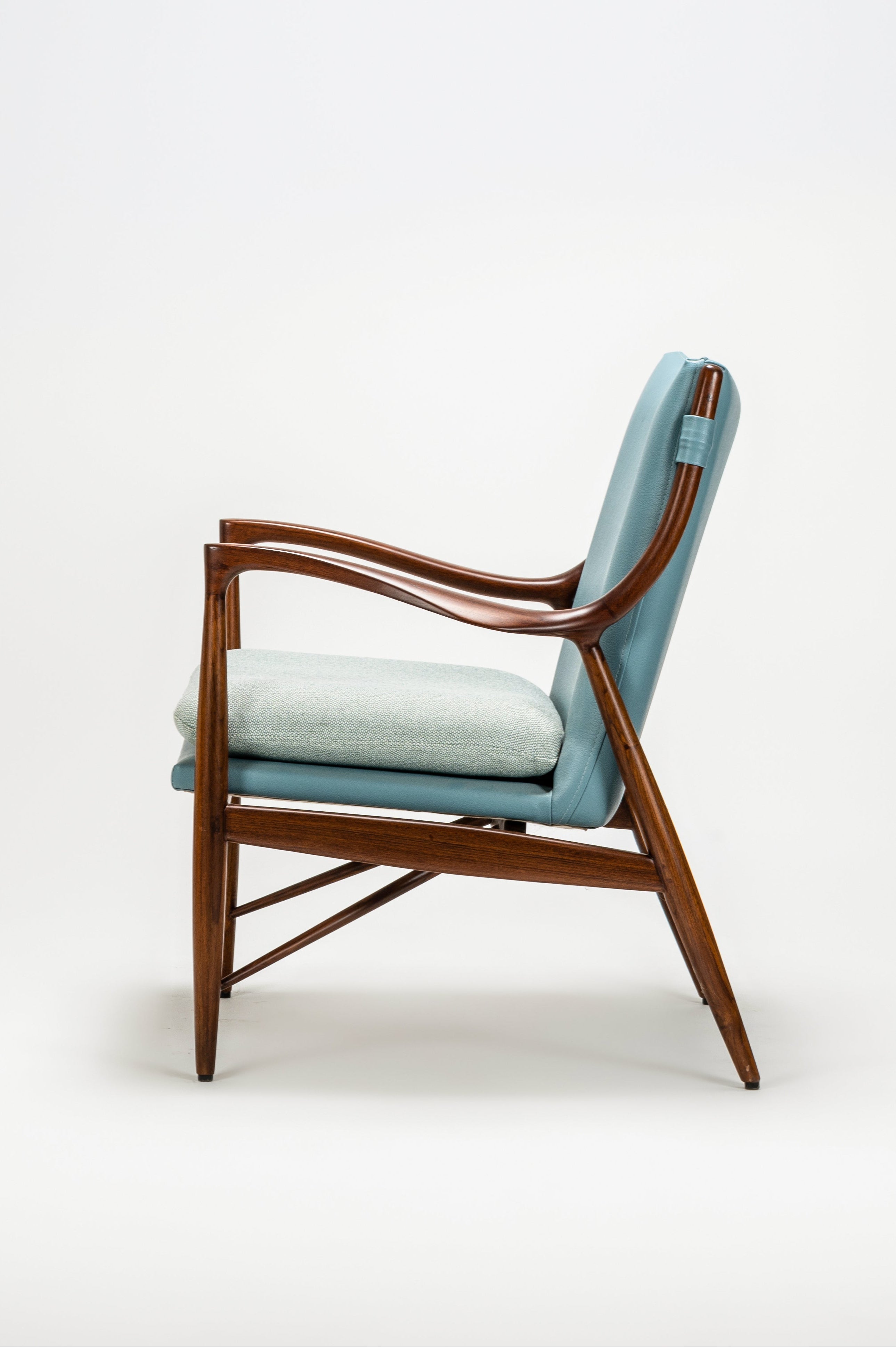 Chair with teal cushion on a white background
