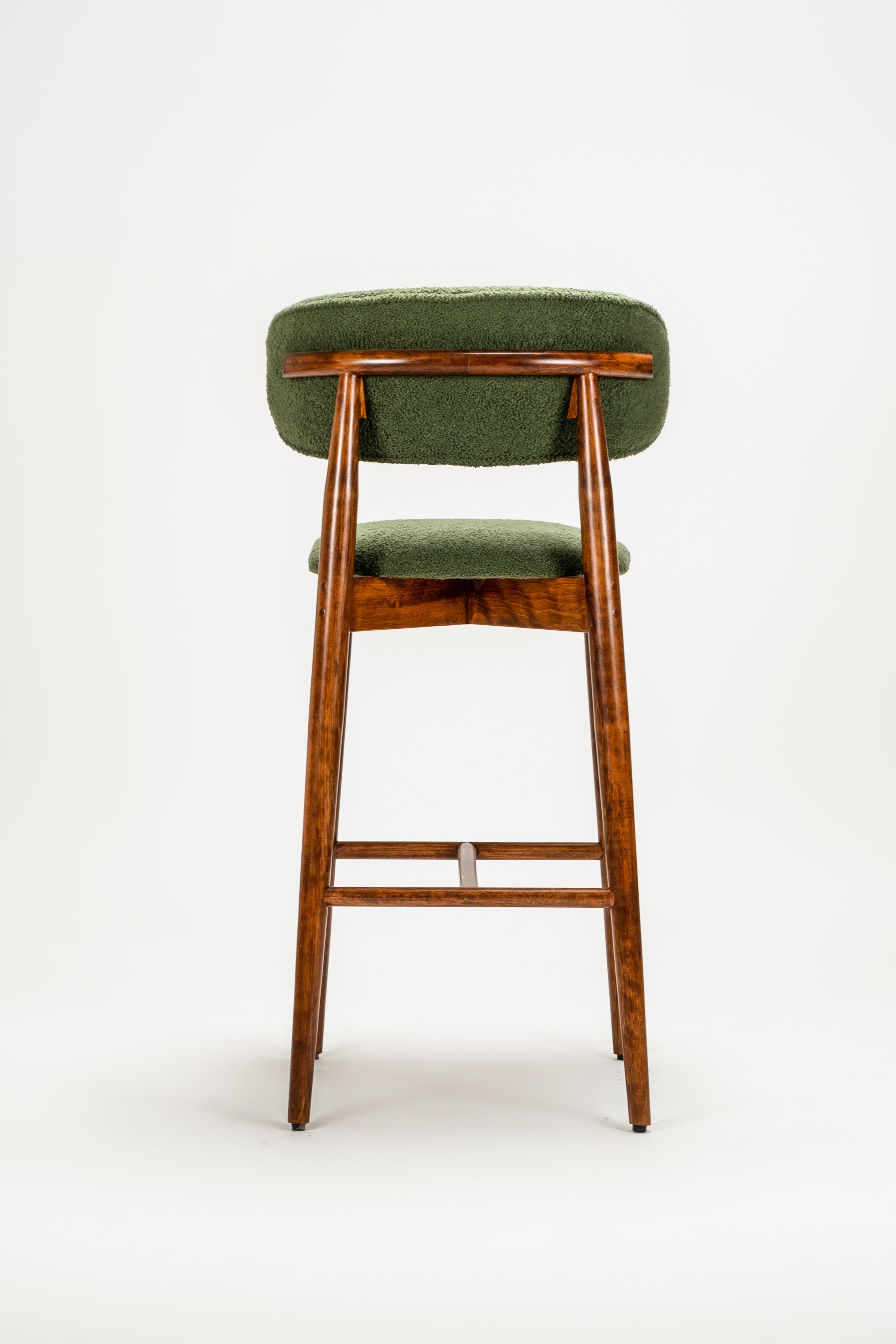 Green bar stool with wooden legs on a white background