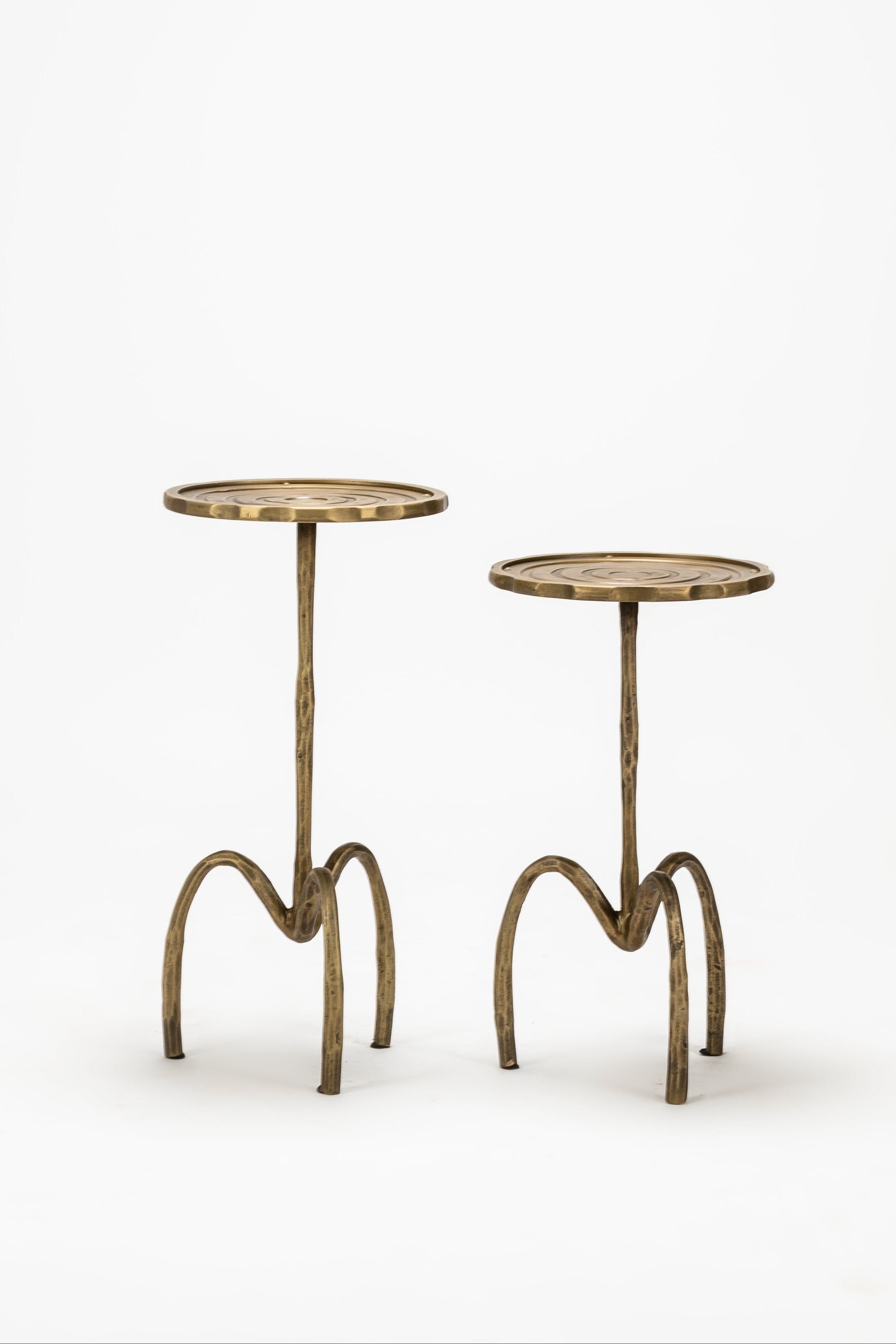 Two small brass tables on a white background