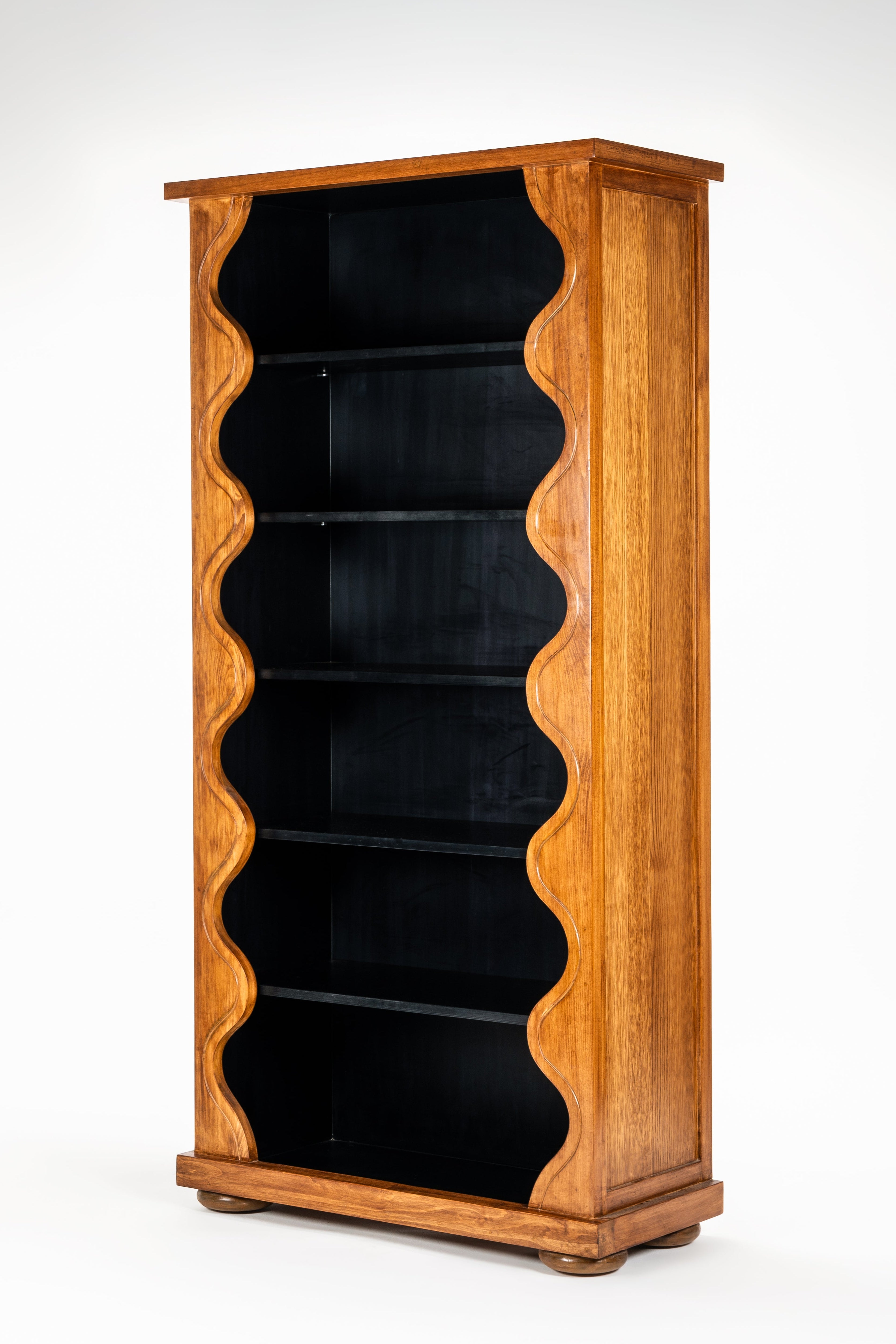 Wooden bookshelf with black interior on a white background
