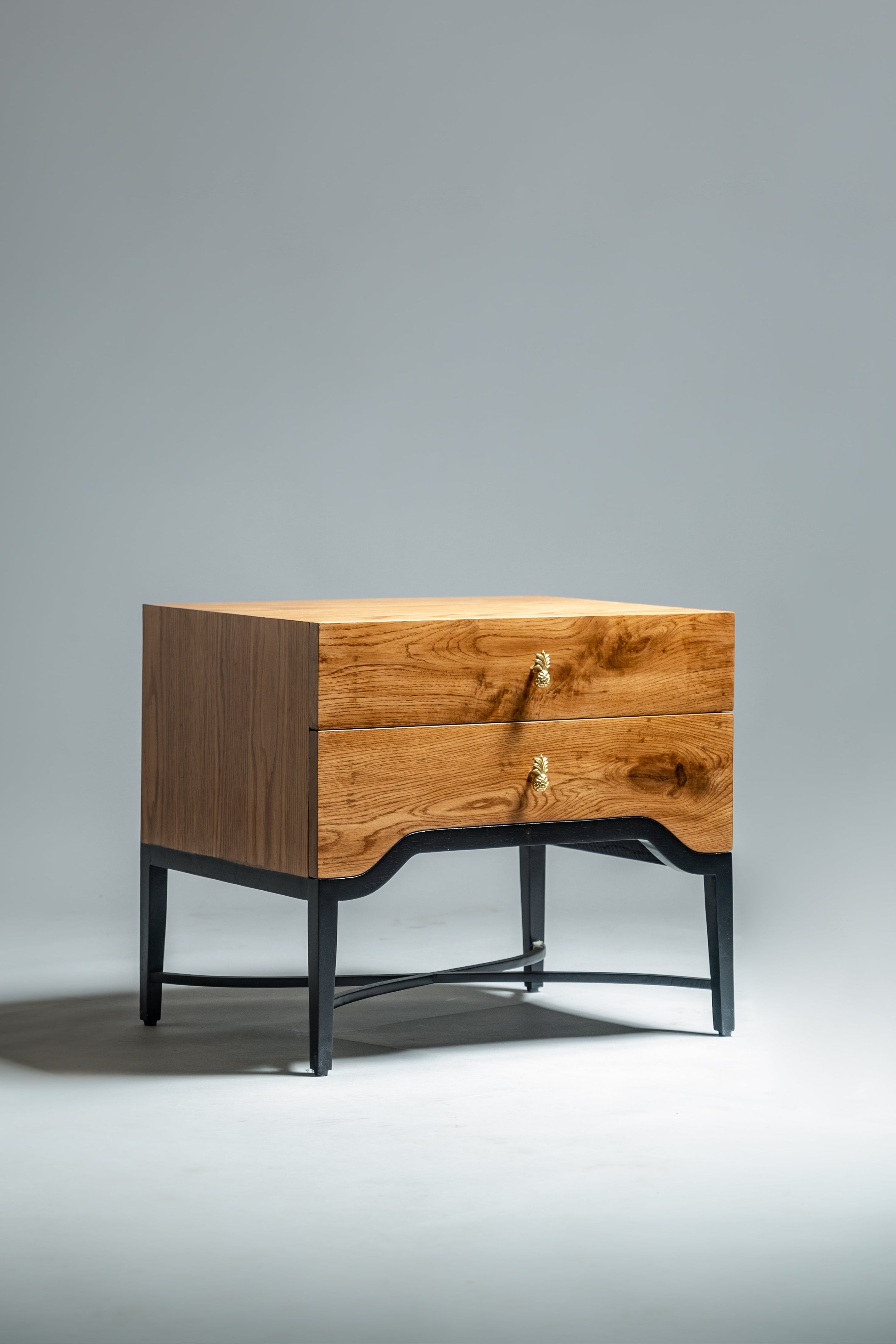 Wooden side table with black metal legs on a gray background