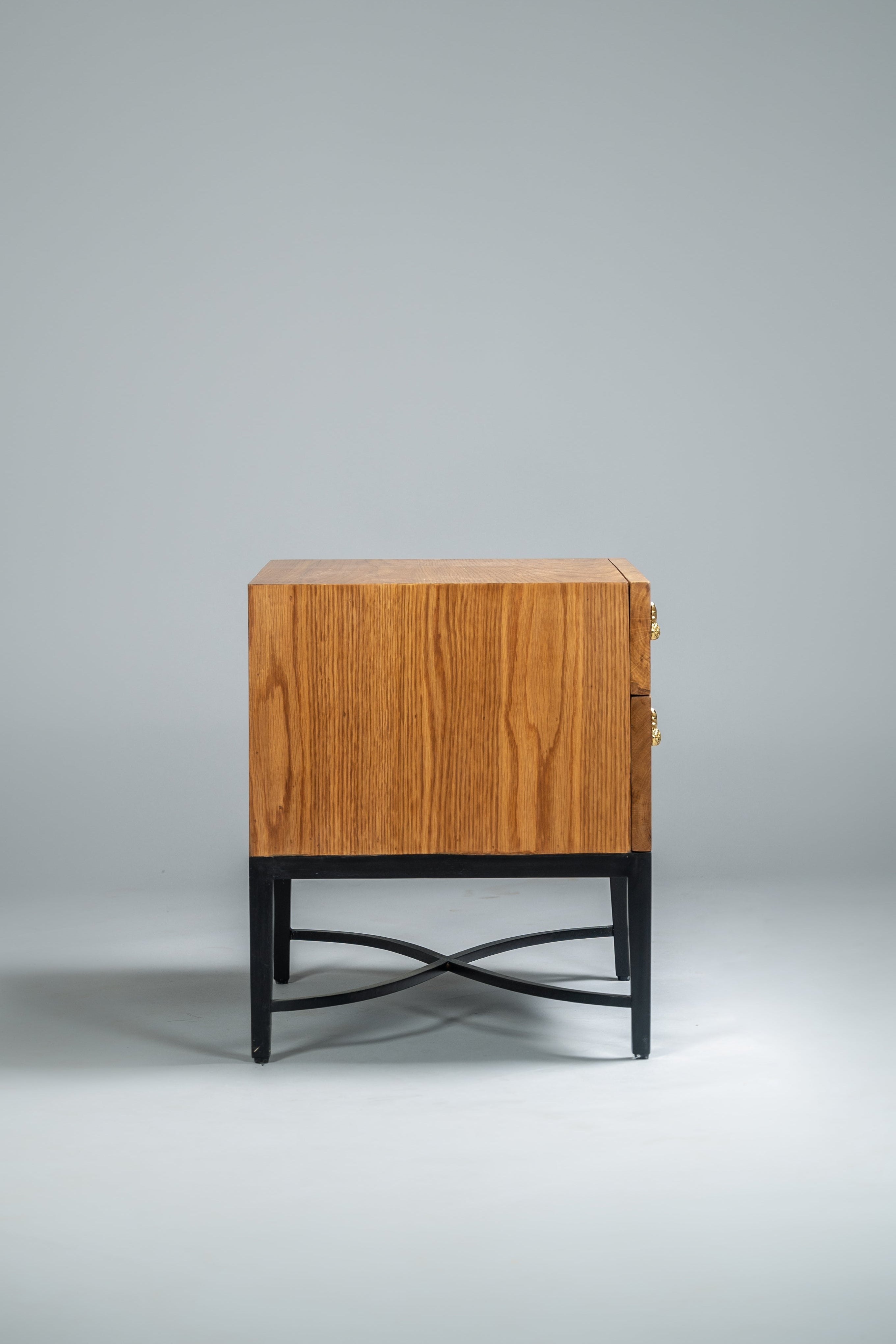Wooden side table with black metal legs on a gray background