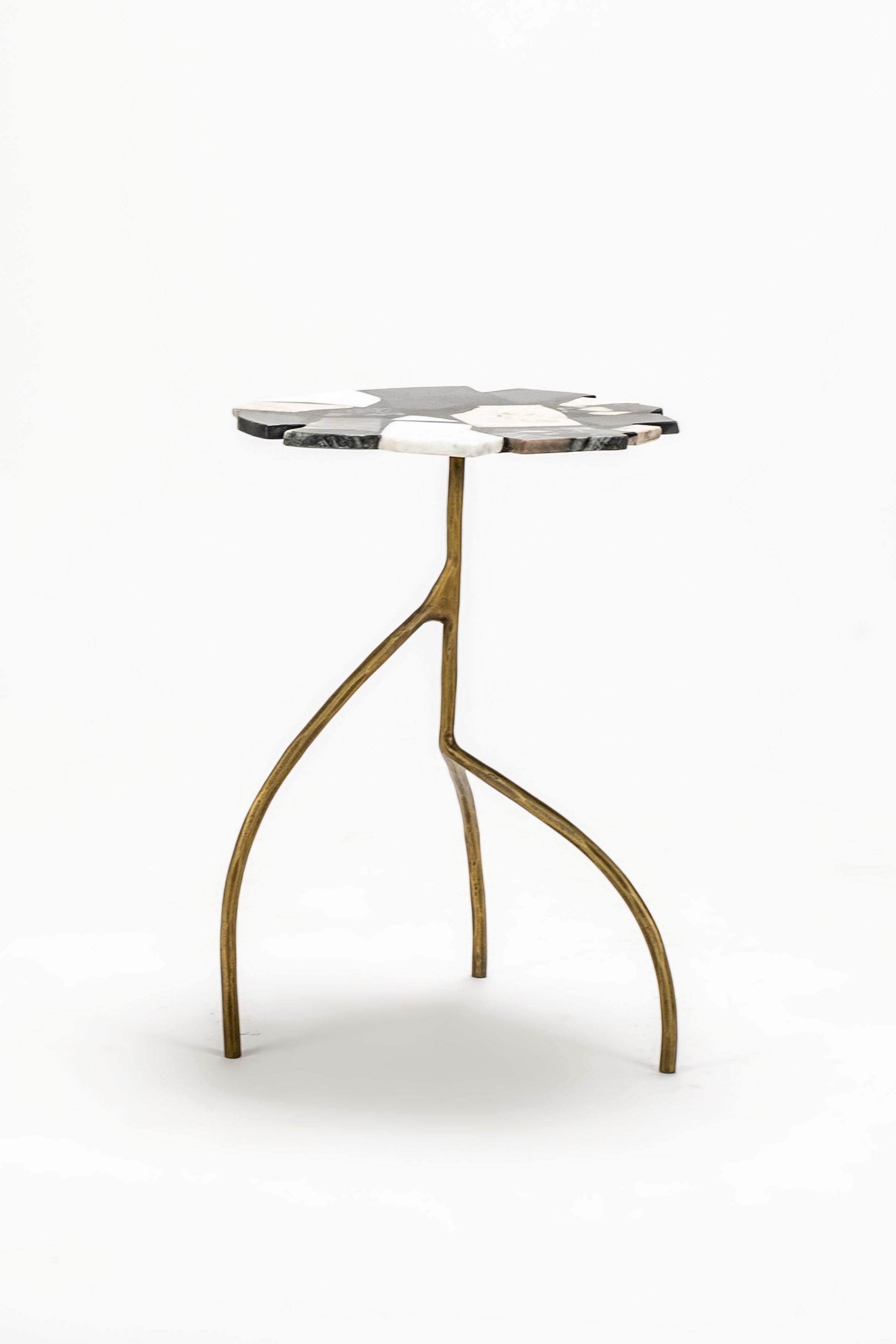 Small round table with a marble top and gold legs on a white background