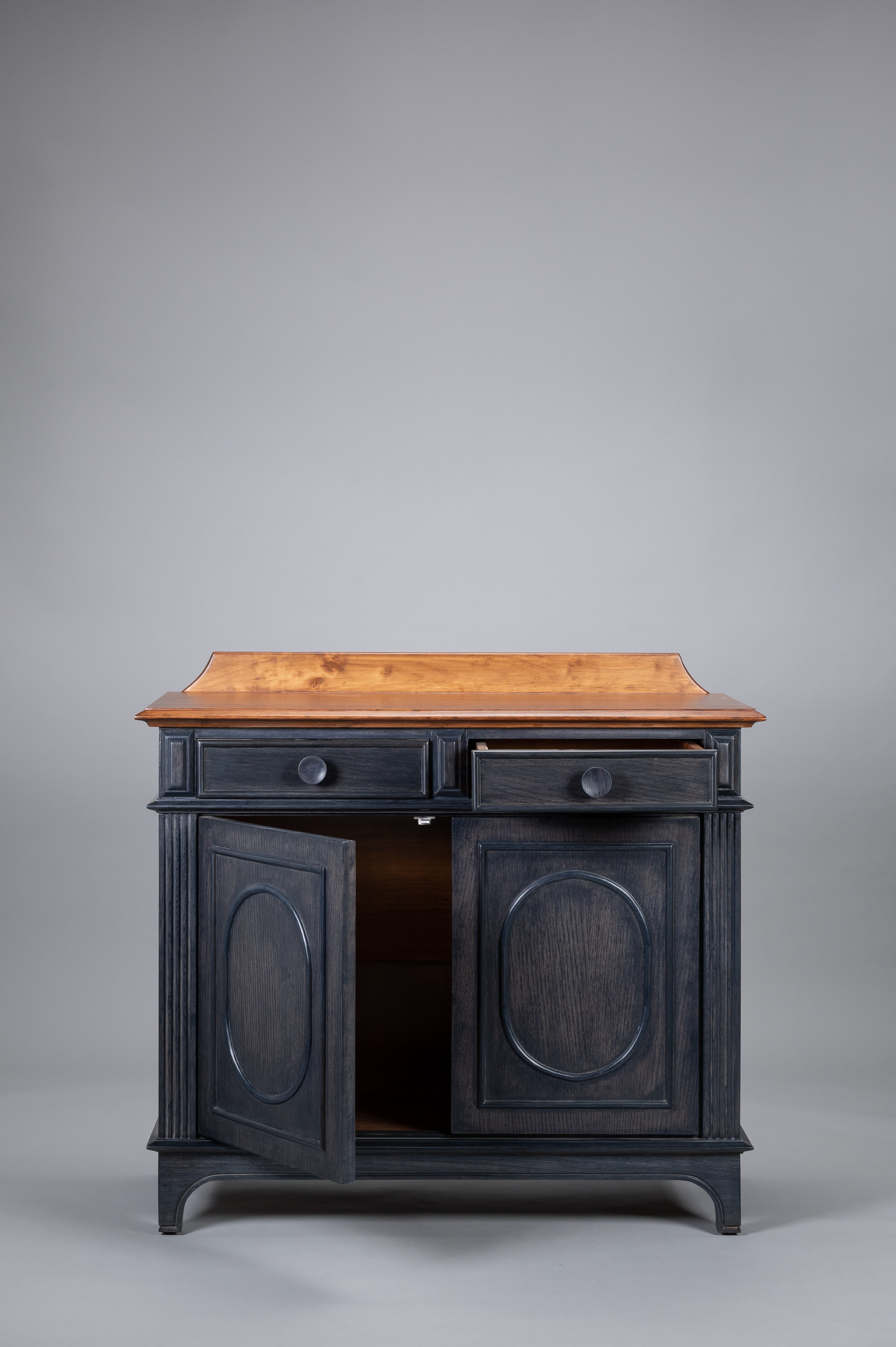 Vintage-style wooden cabinet with black painted doors on a gray background