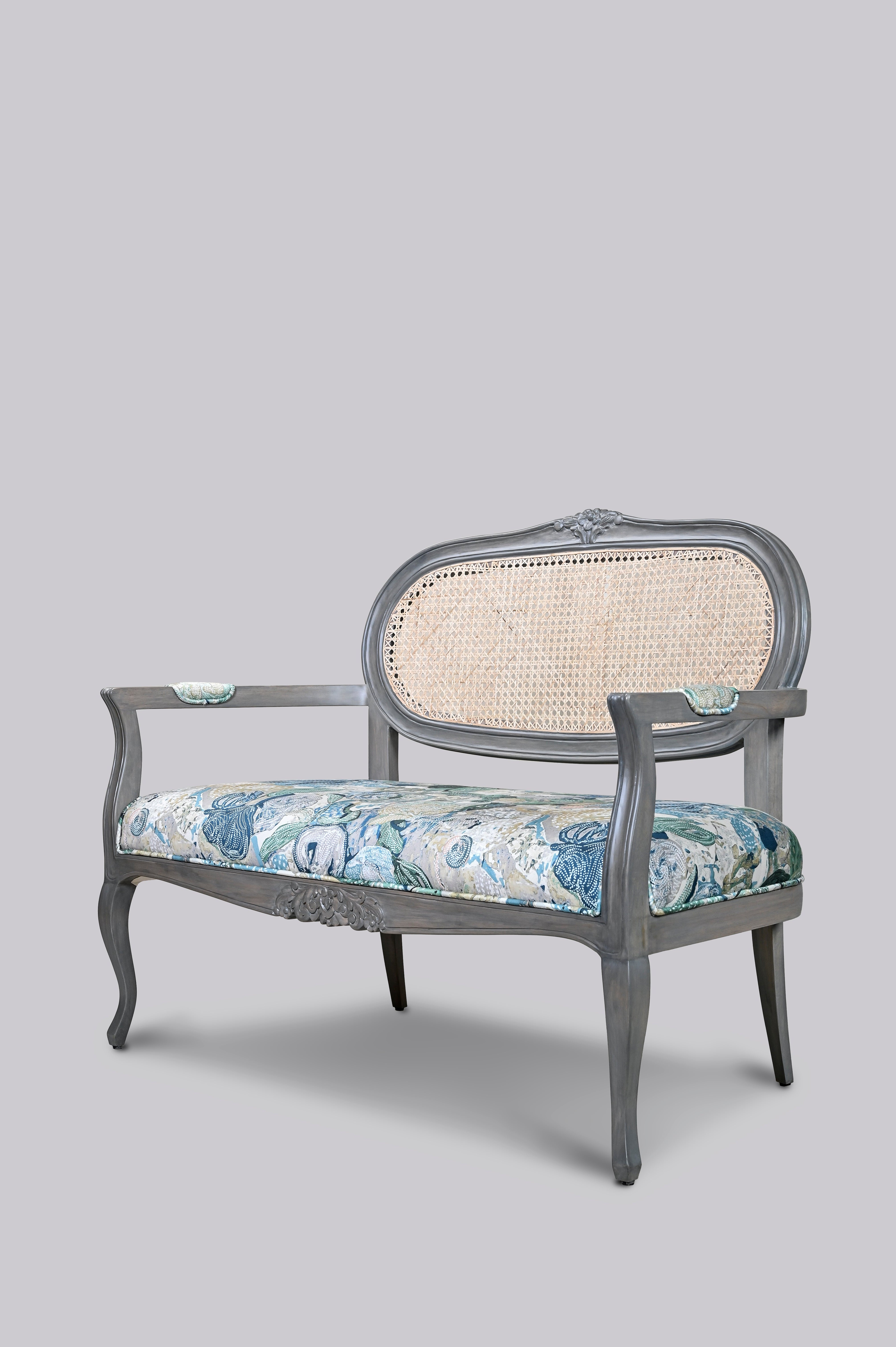 Decorative chair with floral patterned seat on a gray background