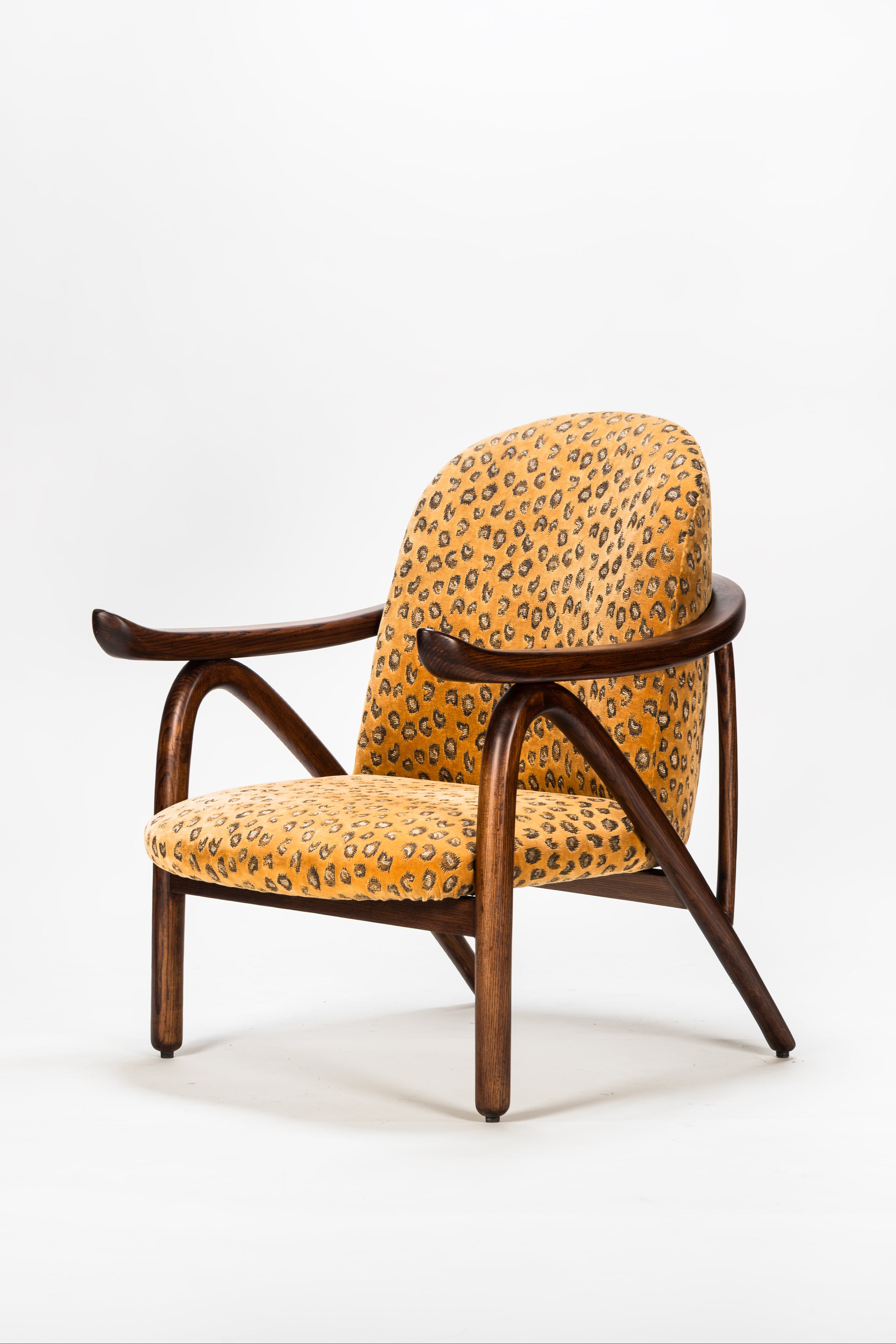 Chair with leopard print upholstery on a white background