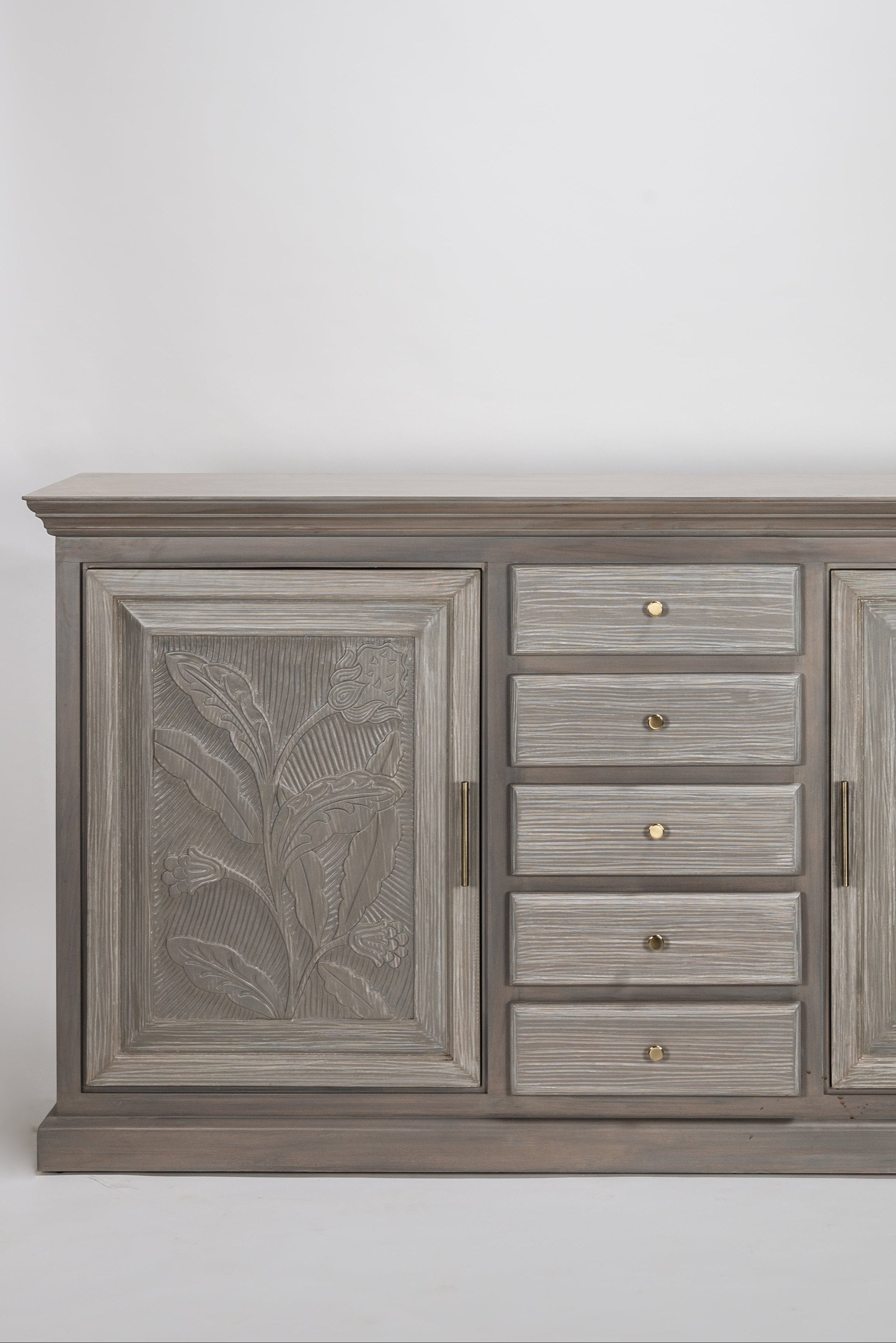 Wooden cabinet with leaf patterns on a white background