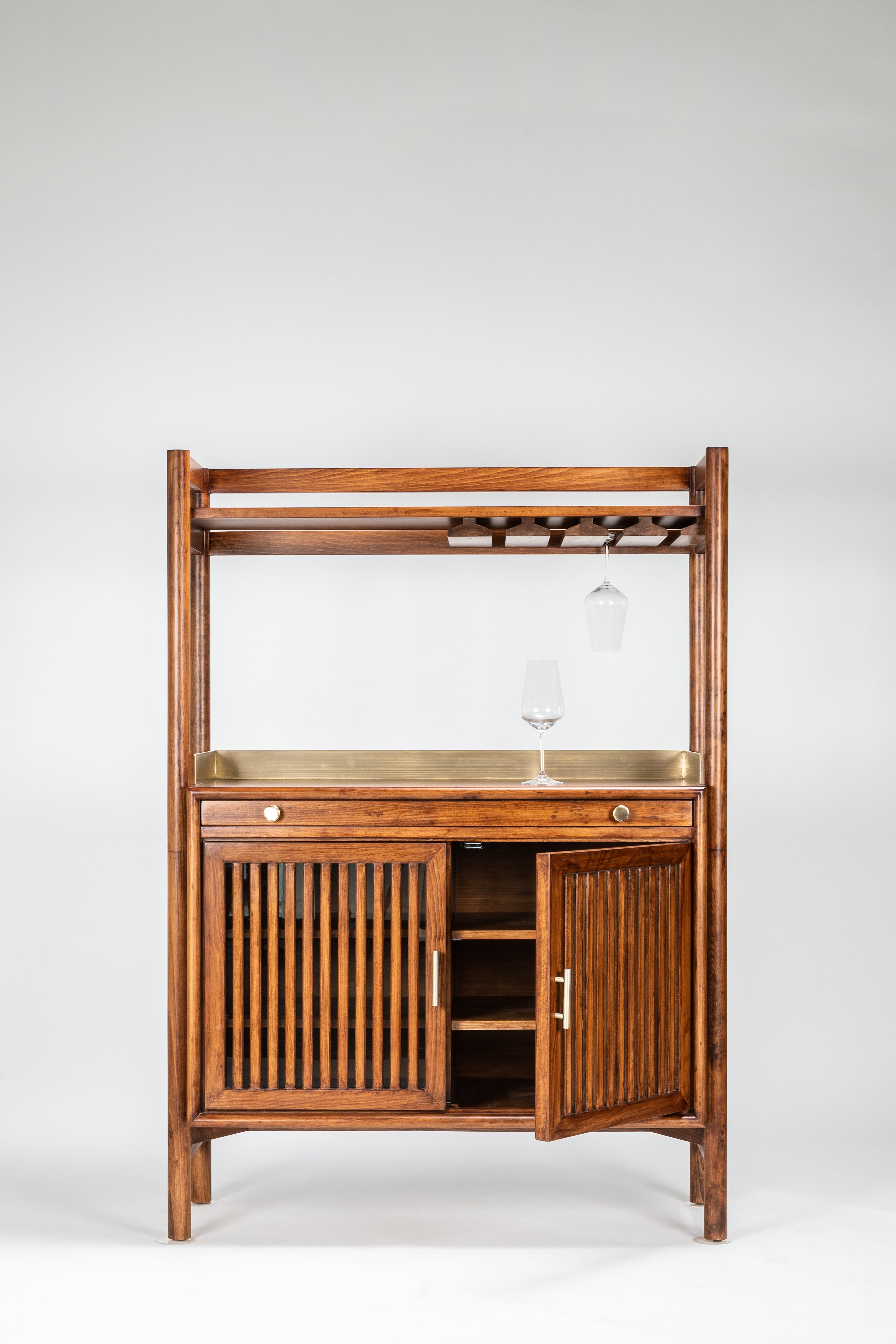Wooden bar cabinet with shelves and a mirror on a white background