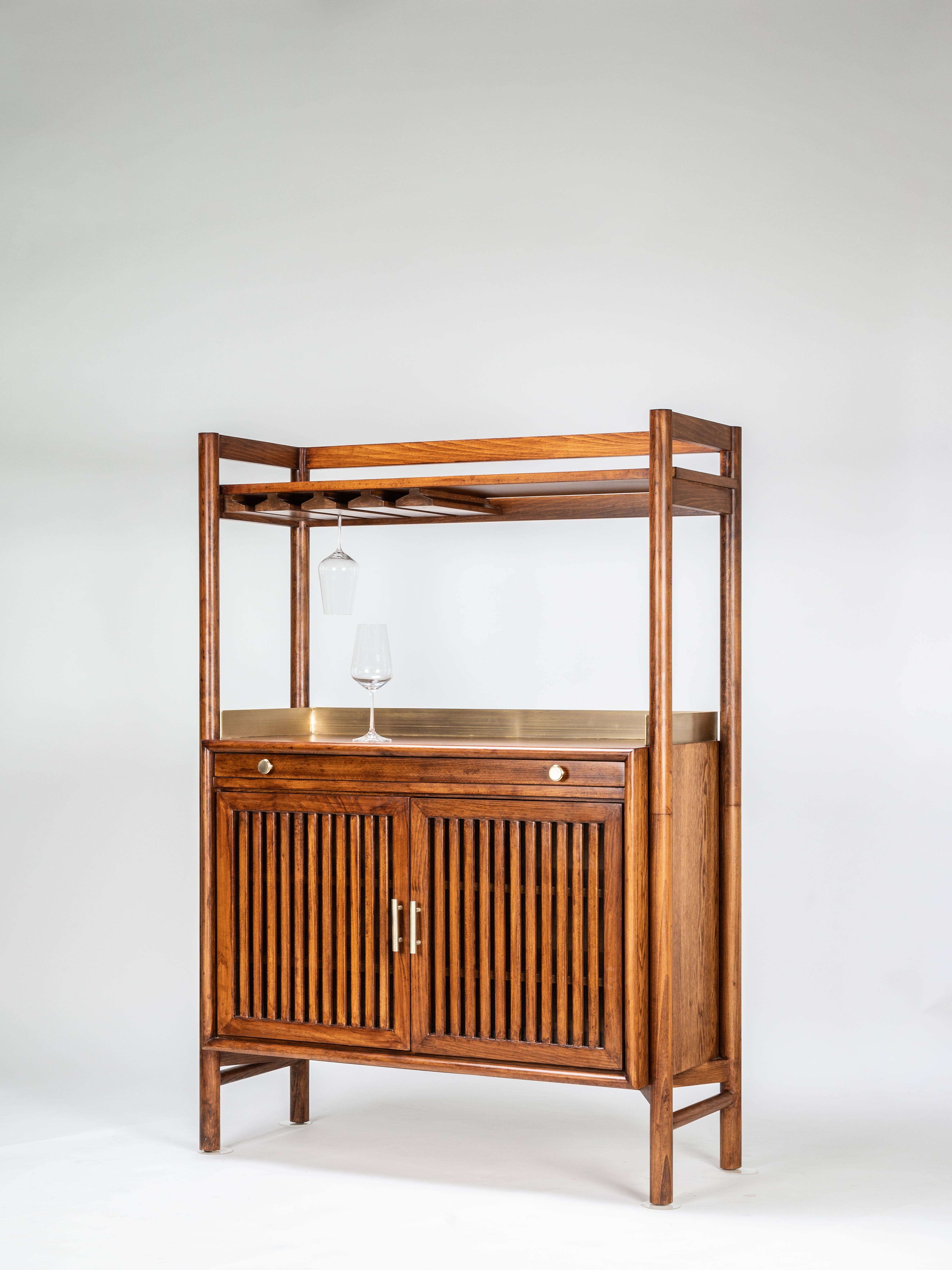 Wooden bar cart with shelves and cabinet doors on a white background