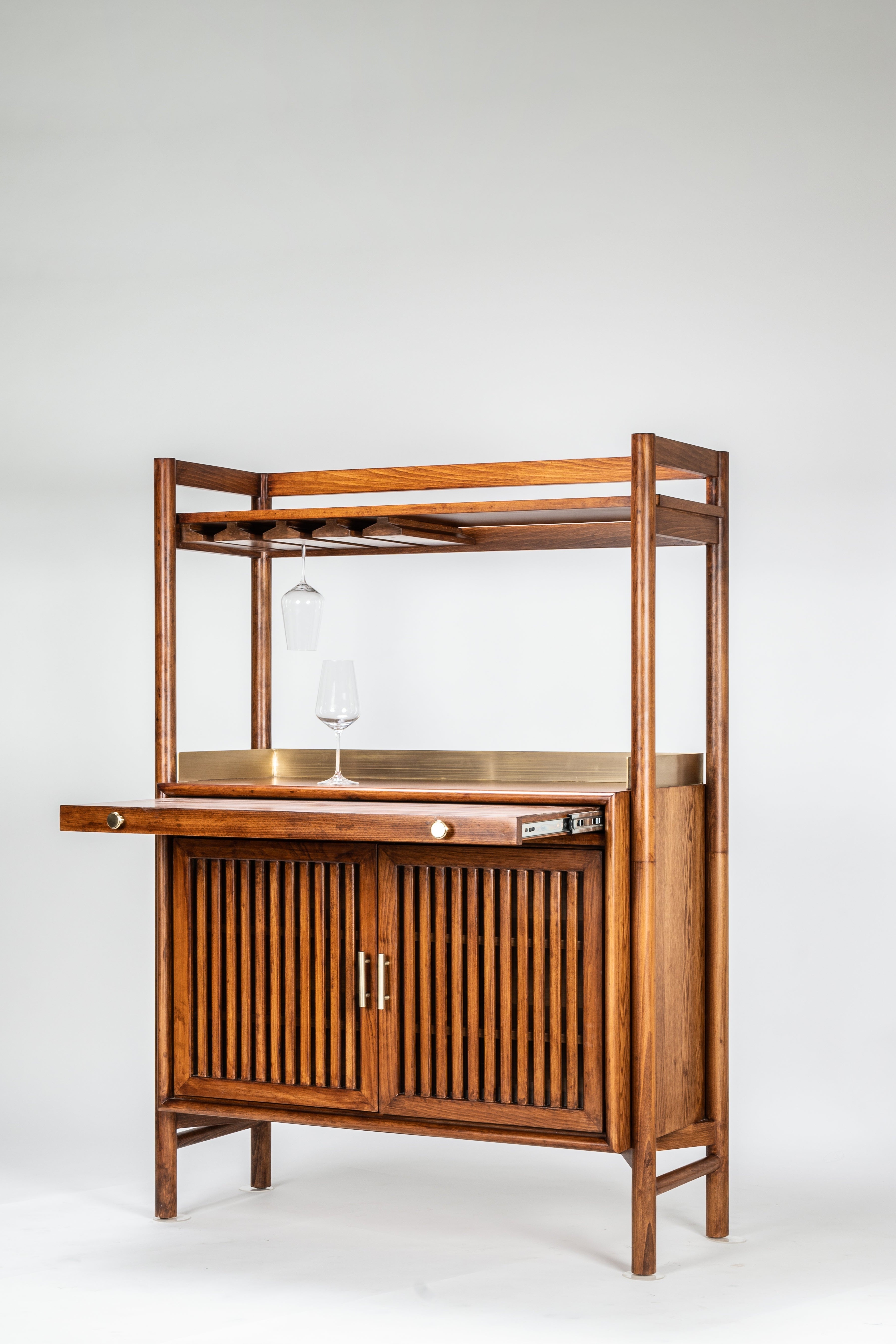 Wooden bar cart with glass shelves on a white background